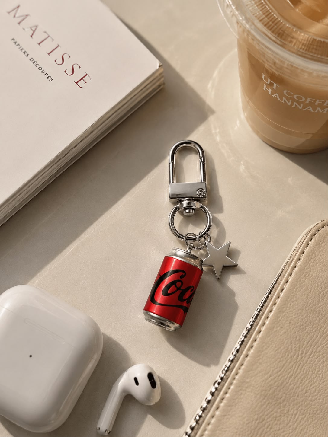 Coca-Cola Star Charm Keychain with Byredo perfume and sunglasses