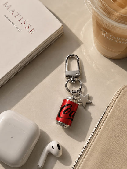 Coca-Cola Star Charm Keychain with Byredo perfume and sunglasses