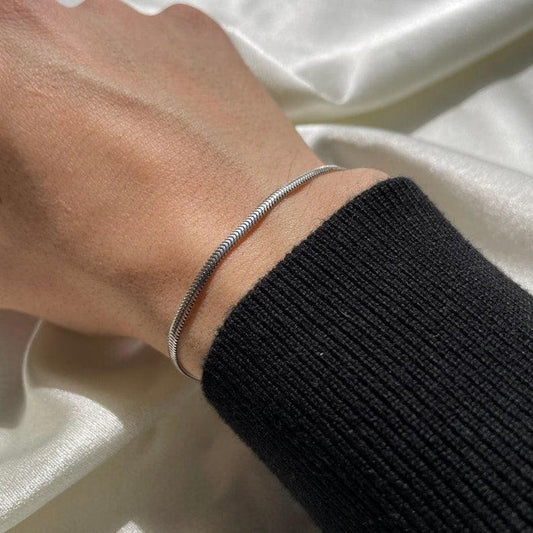 Snake chain bracelet worn on wrist – silver